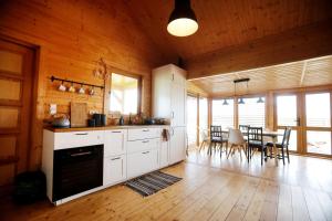 a kitchen with white cabinets and a table with chairs at Domek Całoroczny Powidz tel 512-589-997 in Powidz