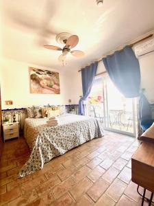 a bedroom with a bed and a ceiling fan at Zenit Olhao B & B with sea view rooftop terrace in Olhão +100 photos