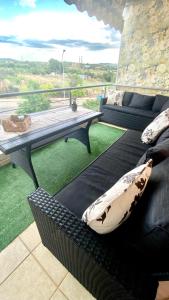 a living room with a couch and a table on a balcony at Sunny Days apartment in Alexandroupoli