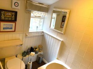 a small bathroom with a toilet and a window at Spacious Georgian Apartment, Central Barnard Castle. in Barnard Castle +22 photos
