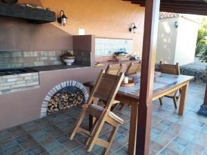 a kitchen with a table and a fire oven at 2 bedrooms villa with sea view private pool and furnished terrace at Puntagorda in Puntagorda