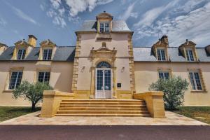 a large building with stairs in front of it at Domaine Grand Piquecaillou - Appartement Pessac Leognan 