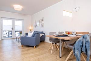 a living room and dining room with a table and chairs at Ferienwohnung Jonte in Sassnitz