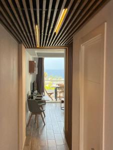 a hallway with a view of a dining room with a table at Hideaway Tenerife Holiday Apartment Las Américas in Playa Fañabe