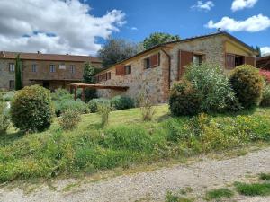 une maison en pierre avec un jardin en face dans l'établissement Casa di campagna in Podere con piscina, à Torrita di Siena