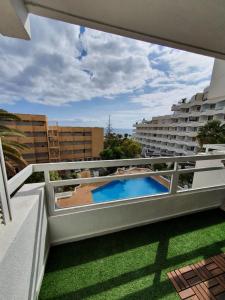 a view from the balcony of a apartment with a swimming pool at Hideaway Tenerife Holiday Apartment Las Américas in Playa Fañabe