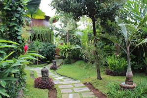 
a garden with plants growing in the middle of it at Dewani Villa Resort in Canggu
