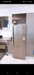 a kitchen with a stainless steel refrigerator at شاليه بورتوسعيد in Port Said