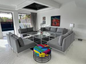 a living room with couches and a glass table at La Villa 2A in Marrakesh