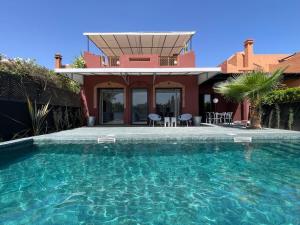 a house with a swimming pool in front of a house at La Villa 2A in Marrakesh