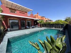 a swimming pool in front of a house at La Villa 2A in Marrakesh +36 photos
