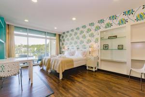 a bedroom with a bed and a desk and a table at Rent4Rest Estoril Beachfront Apartments in Estoril