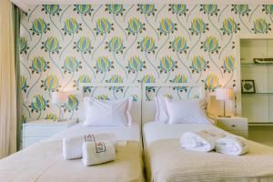 En eller flere senger på et rom på Rent4Rest Estoril Beachfront Apartments