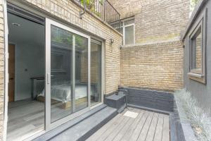 a sliding glass door with a bed on a patio at 189A Caledonian Road, London, N1 0SL in London
