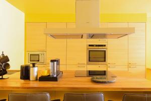 a kitchen with a wooden counter with a stove top oven at 189A Caledonian Road, London, N1 0SL in London