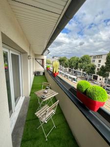 a balcony with two chairs and a table at T3 Flat Moderne sur 2 étages Metro Parking Free Entrance autonome in Rouen