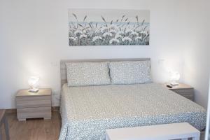 a bedroom with a bed and two night stands at CasAmare in Montesilvano Marina