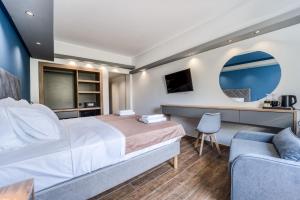 a bedroom with a large bed and a couch at Island City Boutique Hotel in Rhodes Town