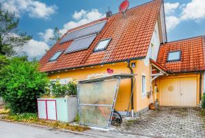 une maison avec des panneaux solaires en haut dans l'établissement Zum Engelreich ruhig, ländlich, stadtnah, à Munich