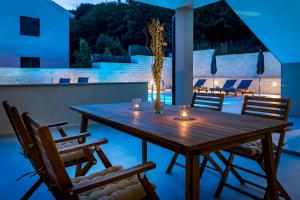 a wooden table on the patio of a house at Vortex apartments, Opatija Riviera in Matulji