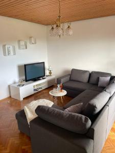 a living room with a couch and a tv at Apartment " So" in Senj