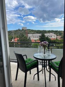 a table and chairs on a balcony with a view at Apartment " So" in Senj