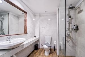 a bathroom with a toilet and a sink and a shower at Island City Boutique Hotel in Rhodes Town