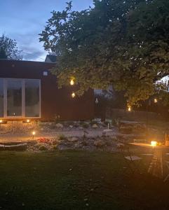 a backyard at night with lights in the yard at Tiny House 47 in Egloffstein