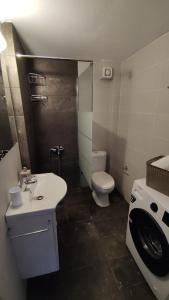 a small bathroom with a toilet and a sink at SUN KISS HOUSES Sun Kiss Houses B in Áyios Spirídhon