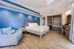 a bedroom with a bed and a couch at Island City Boutique Hotel in Rhodes Town