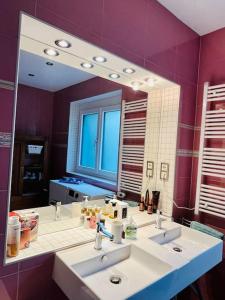 a bathroom with two sinks and a large mirror at Landhaus Apartment in Pettnau