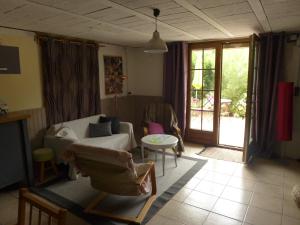 ein Wohnzimmer mit einem Sofa und einem Tisch in der Unterkunft Grand appartement au calme in Lérouville