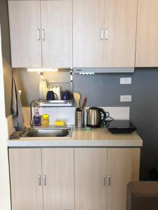 a kitchen with a sink and a counter top at Cozy Apartment for travelers and homestays in Suba