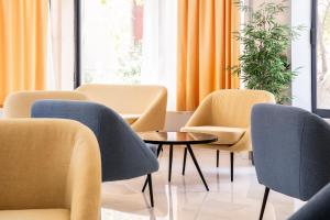 a waiting room with chairs and a table at Island City Boutique Hotel in Rhodes Town