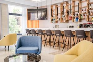 a barber shop with blue chairs and a counter at Island City Boutique Hotel in Rhodes Town