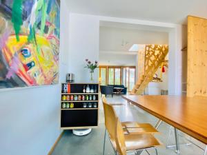 a dining room with a table and a painting at Loft mit Dachterrasse in Bernau am Chiemsee