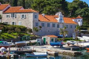a large building with boats docked in a harbor at Holiday Home Bezic in Grohote