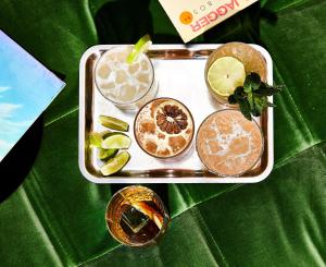 a tray with three different types of drinks on a table at Kimpton Sawyer Hotel by IHG in Sacramento