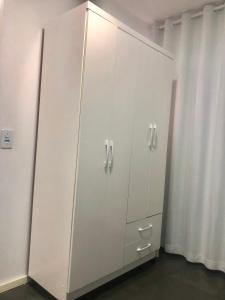 Habitación con armario blanco con armarios blancos. en Pousada 714 en Brasilia