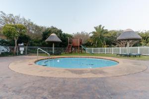 a small pool with a playground and a swing at Pinnacle Point Lodge 21 in Mossel Bay