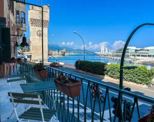 a balcony with benches and a view of the water at Bilocale fronte Porto Antico in Savona