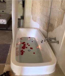 a bath tub filled with blood in a bathroom at Alla dimora di Chiara Suite and Rooms in Matera