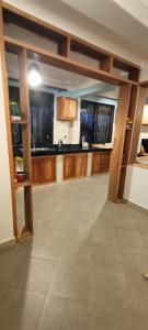 a large kitchen with wooden cabinets and a tile floor at Cosy Living in Gulu