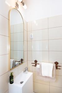 a bathroom with a sink and a mirror at Panorama Residence in Balatonalmádi