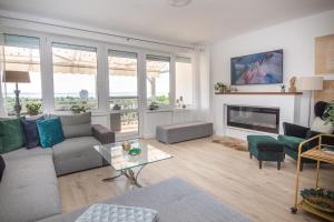 a living room with a couch and a fireplace at Panorama Residence in Balatonalmádi