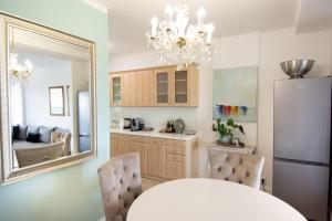 a kitchen with a mirror and a table and a refrigerator at Panorama Residence in Balatonalmádi