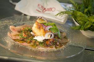 a plate with a dish of food on a table at Hotel Bruno in Fügen