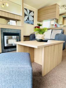 a kitchen and living room with a table and a couch at Cosy Corner in Filey