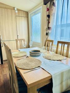 a dining room table with glasses and plates on it at Cosy Corner in Filey +71 photos