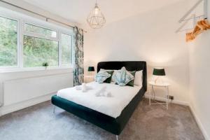 a bedroom with a bed and a window at Standout 2BD Coastal Cottages in South Devon in Shaldon